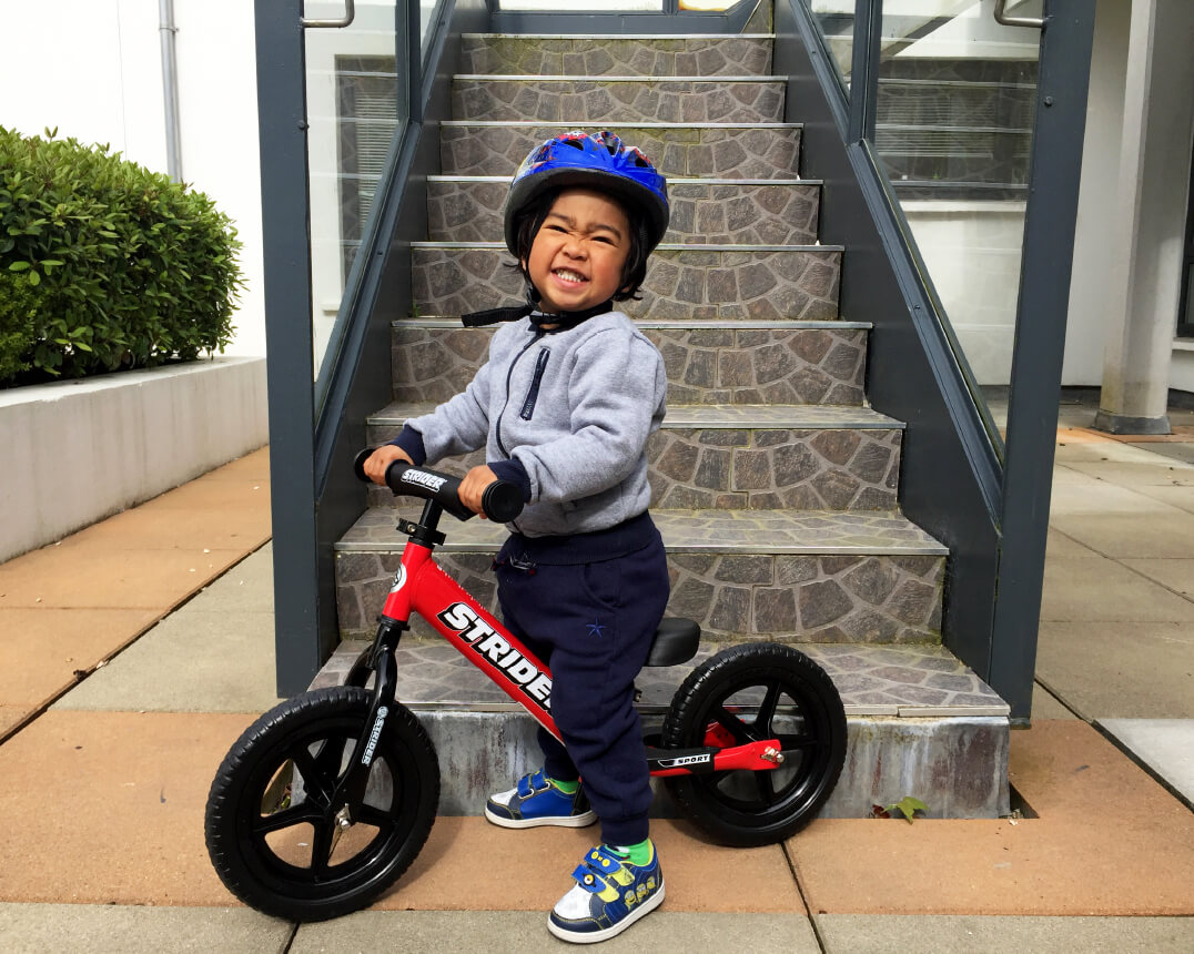 Child on red Strider 12 Sport Balance Bike